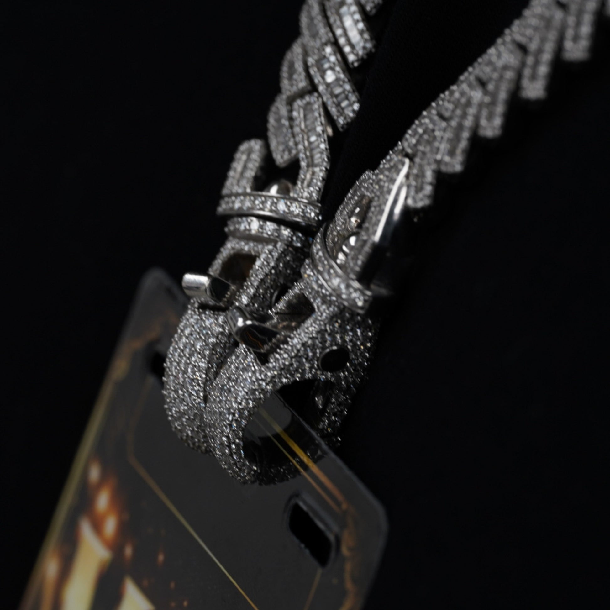 Close-up of diamond-studded clasp on VIP credential chain display stand