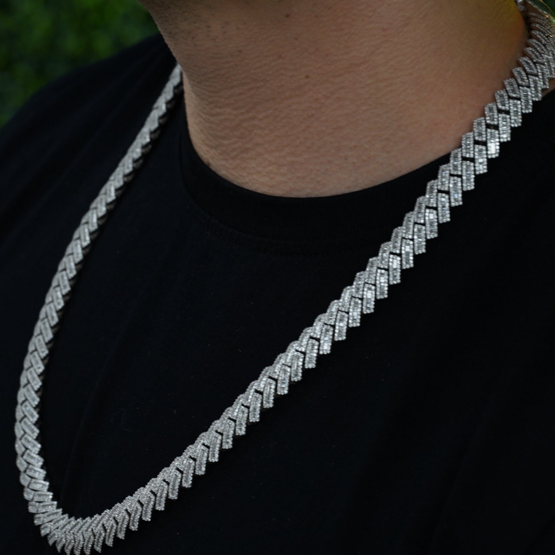 Diamond studded 10 karat white gold VIP credential chain draped across chest outdoors