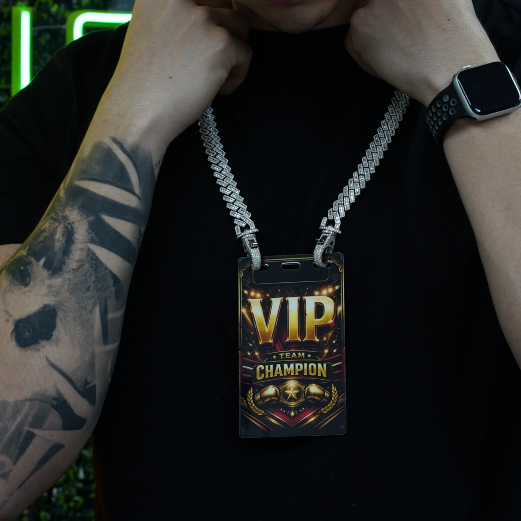 Tattooed model wearing diamond studded VIP credential chain and badge with hands raised