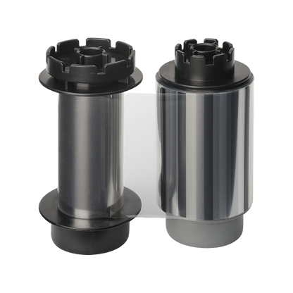 Two cylindrical rolls of film, one with a black and clear body and the other with a shiny silver body, both featuring black end caps, ideal for use with the Evolis RTCL009NAA Clear Transfer Ribbon - 500 Prints, compatible with Avansia Retransfer ID Card Printers.  Sold by Specialist ID, an authorized Evolis dealer.