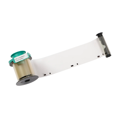 A roll of transparent plastic film with a green label and black markings, partially unrolled, perfect for use in ID card printers as the Evolis LVA038NAA Clear Varnish Ribbon - 1200 Prints, Compatible with Primacy2 and Avansia Lamination includes an essential protective layer for ID cards.