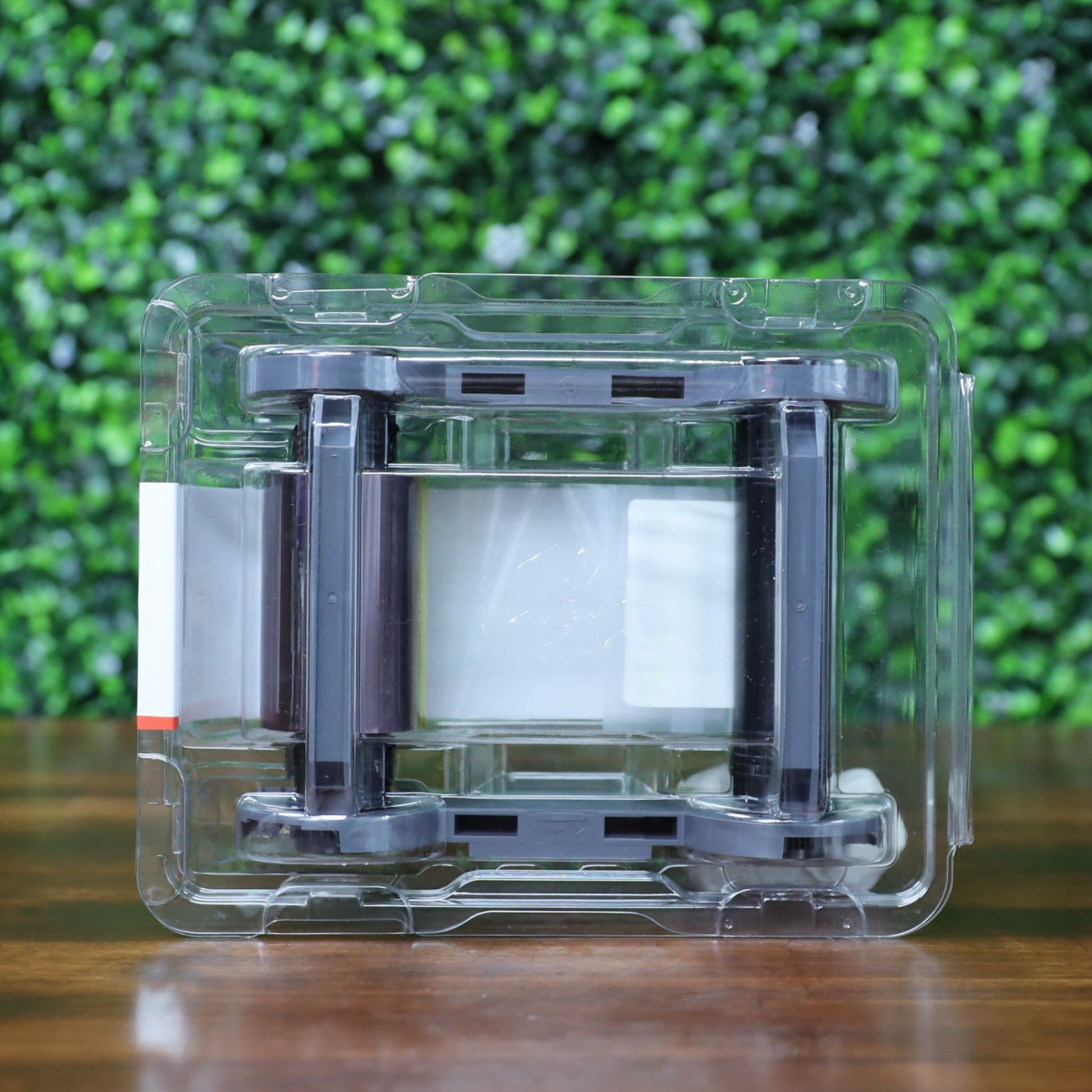 Top view of Evolis R5F002AAA YMCKO ribbon sealed in clear clamshell packaging. Ribbon spools and cassette housing clearly visible. Photographed and sold by Specialist ID, an authorized Evolis dealer.