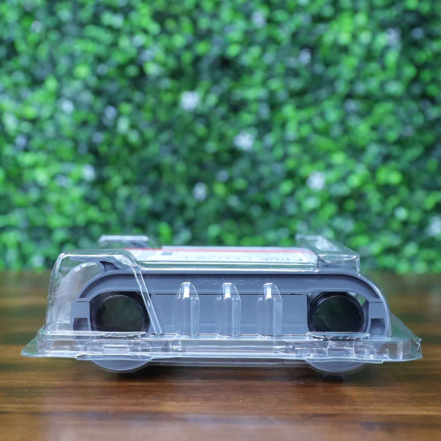 Top-down view of packaged Evolis R5F008AAA YMCKO ribbon showing clamshell form, side cartridge positioning, and protective casing. Photographed and sold by Specialist ID, an authorized Evolis dealer.