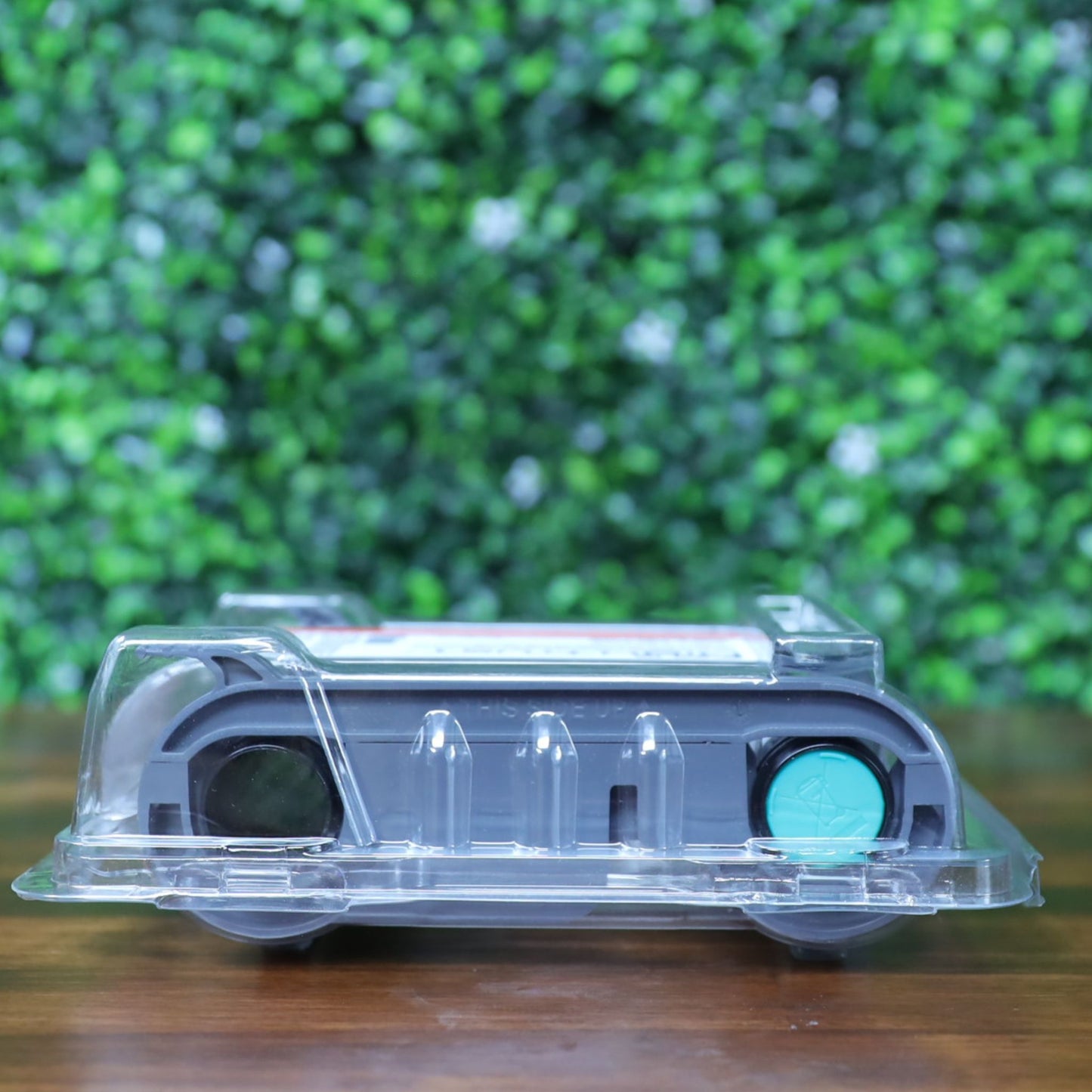 ight-side flat view of the Evolis R6F203A100 YMCKO-K ribbon in sealed clamshell packaging, showing teal and black spool caps. Photographed and sold by Specialist ID, an authorized Evolis dealer.