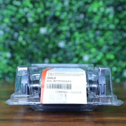 Back view of Evolis RCT216NAAA metallic gold monochrome ribbon in sealed clamshell packaging, showing barcode, lot number CO0001021, and P/N: RCT216NAAA label. Photographed and sold by Specialist ID, an authorized Evolis dealer.