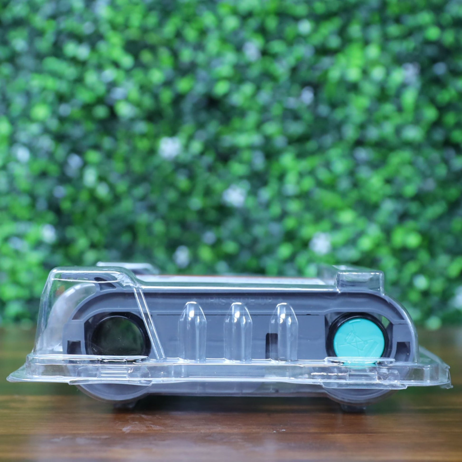 Side view of the Evolis RCT216NAAA metallic gold monochrome ribbon in sealed clamshell packaging, showing black and teal spools through the clear plastic. Photographed and sold by Specialist ID, an authorized Evolis dealer.