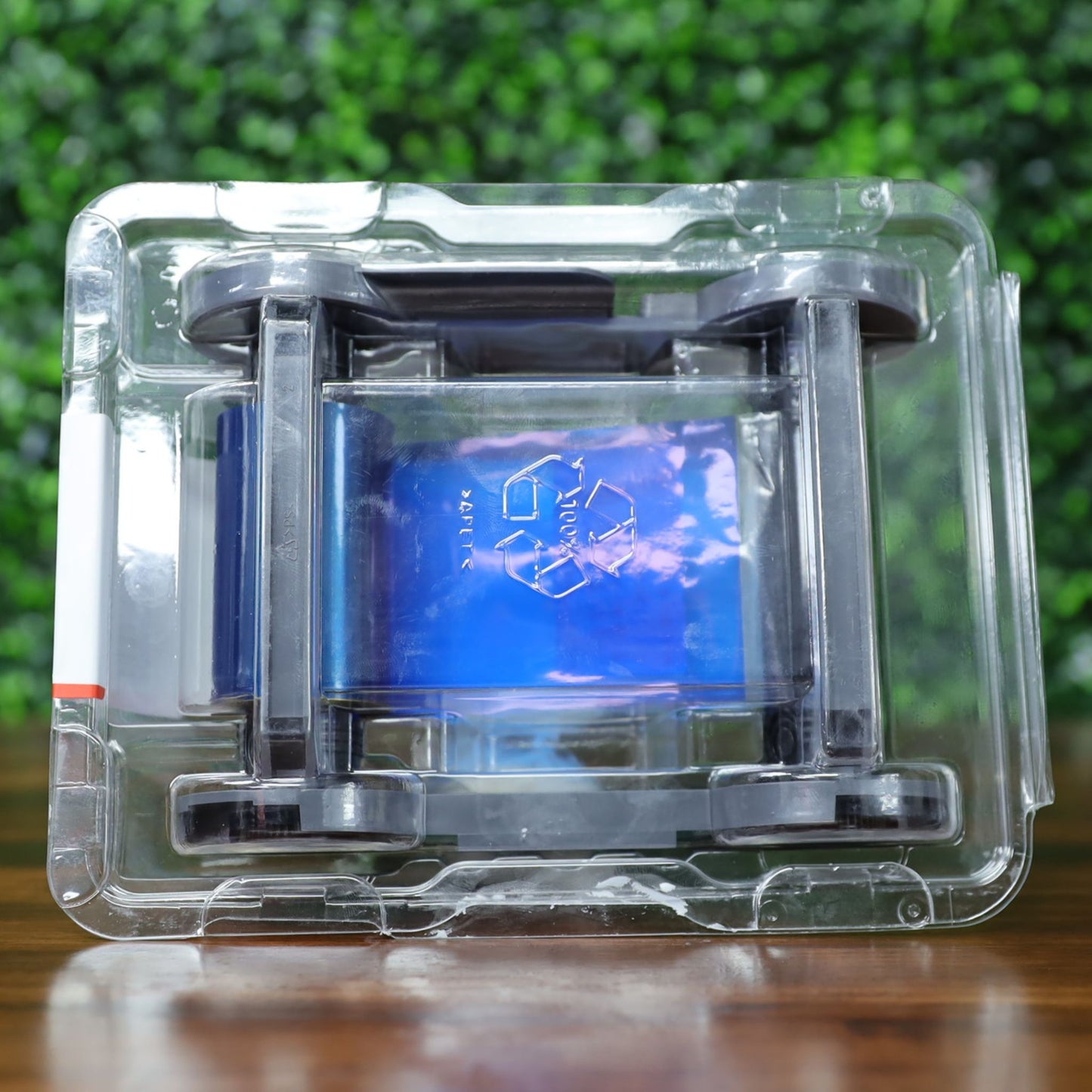 Top view of Evolis RCT216NAAA metallic gold monochrome ribbon in sealed plastic packaging, with visible blue inner wrap and recycle embossing on the film. Photographed and sold by Specialist ID, an authorized Evolis dealer.