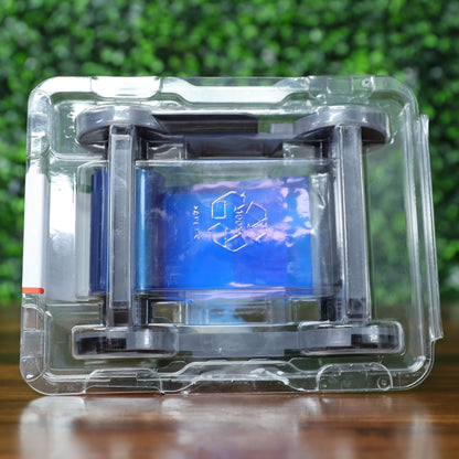 Top view of Evolis RCT216NAAA metallic gold monochrome ribbon in sealed plastic packaging, with visible blue inner wrap and recycle embossing on the film. Photographed and sold by Specialist ID, an authorized Evolis dealer.