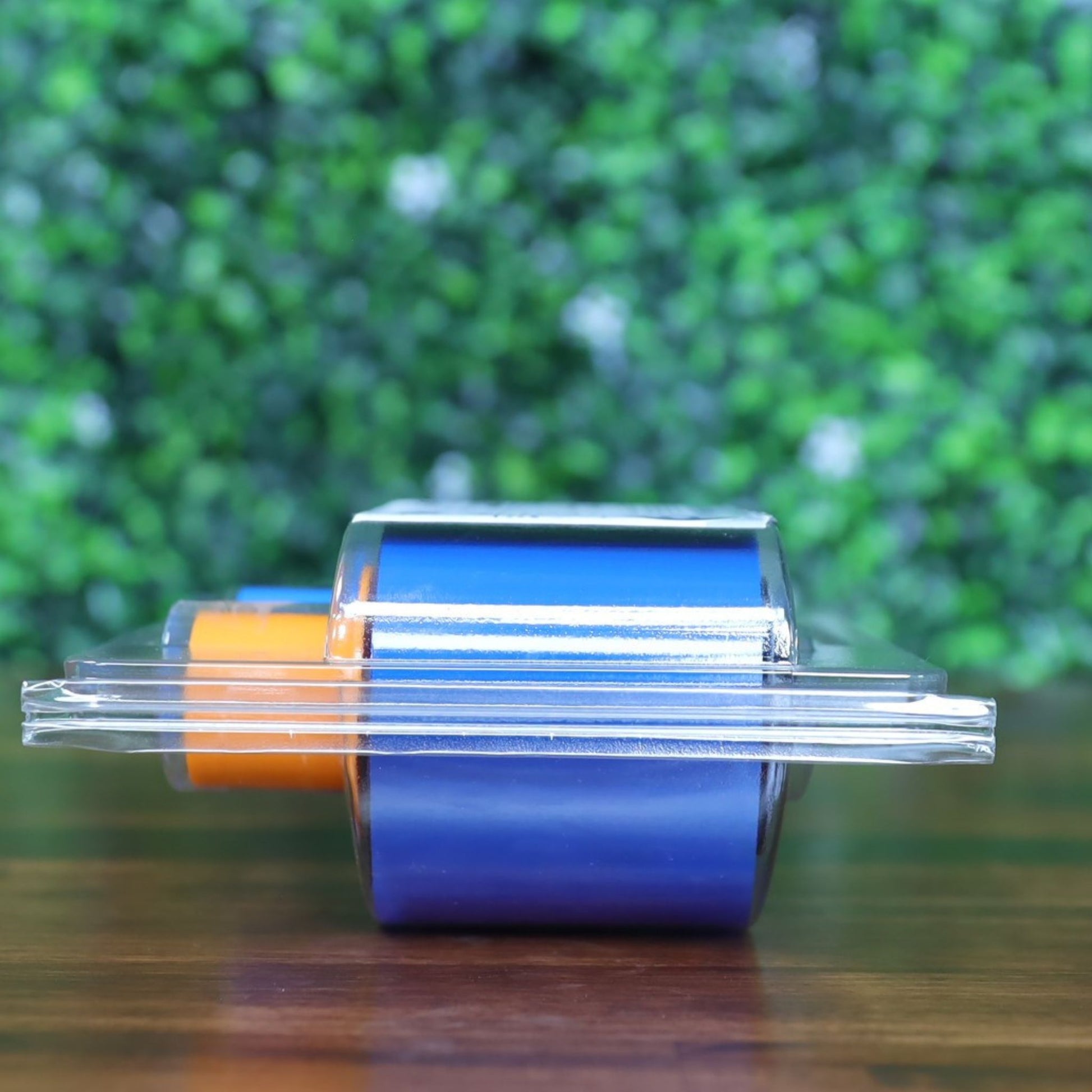 Side view of Fargo 45611 YMCKOK color ribbon showing vibrant orange and blue spools through transparent plastic packaging. Photographed and sold by Specialist ID, an authorized Fargo dealer.

Ready for the next?