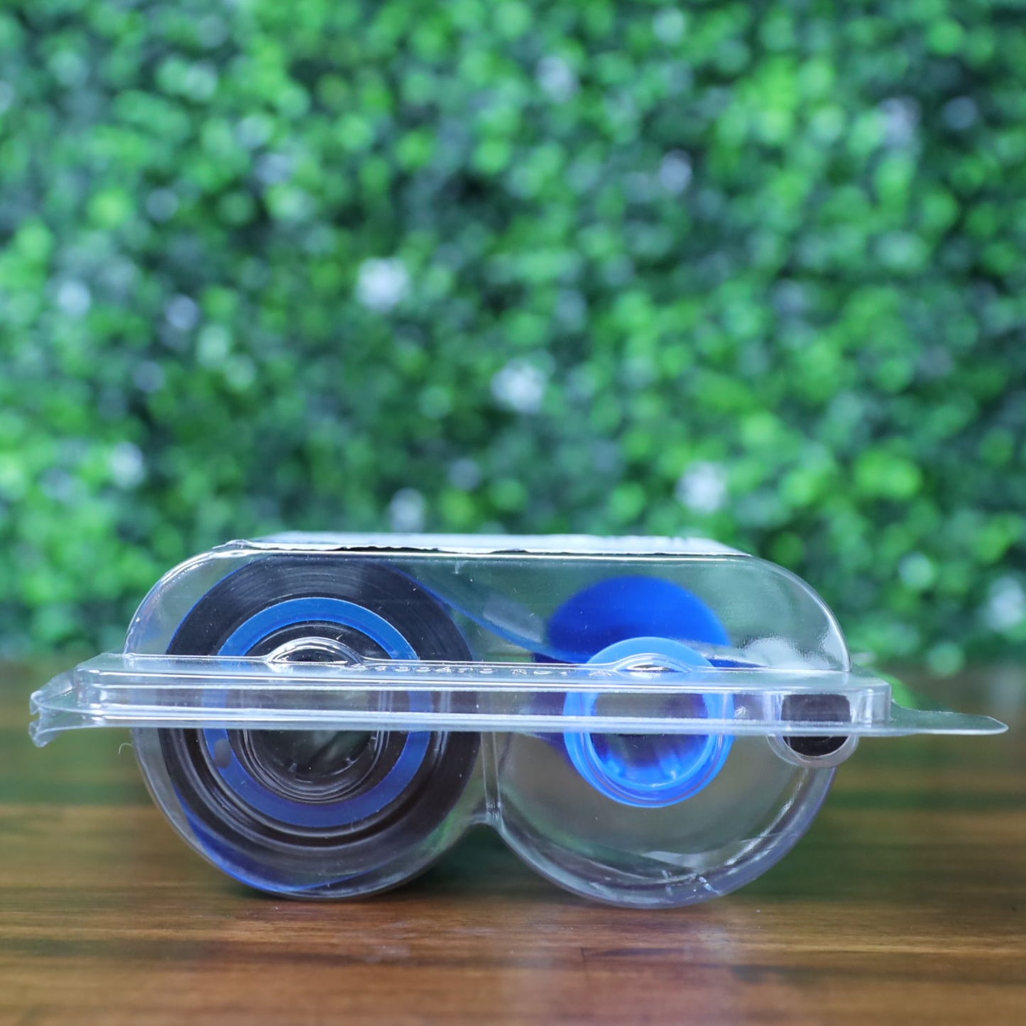 Side profile of the Fargo 45611 YMCKOK ribbon showing black and blue spool hubs enclosed in factory-sealed plastic packaging. Photographed and sold by Specialist ID, an authorized Fargo dealer.