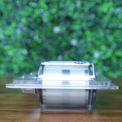 Top-down view of the Fargo 82601 PolyGuard laminate ribbon inside clear plastic clamshell packaging, showing partial visibility of the holographic overlay film. Photographed and sold by Specialist ID, an authorized Fargo dealer.