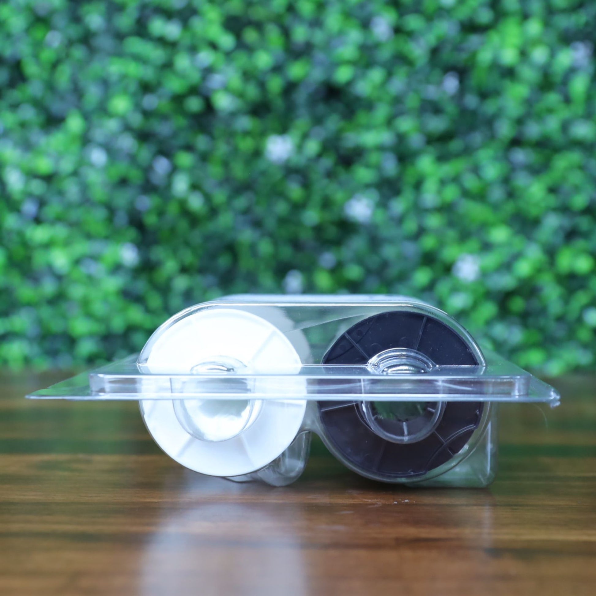 Side view of Fargo 82604 holographic PolyGuard laminate showing black and white supply rollers inside clamshell packaging. Photographed and sold by Specialist ID, an authorized Fargo dealer.