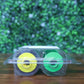 Side view of Fargo 84500 retransfer film in sealed packaging showing yellow and green ribbon spool cores through clamshell case. Photographed and sold by Specialist ID, an authorized HID Fargo dealer.