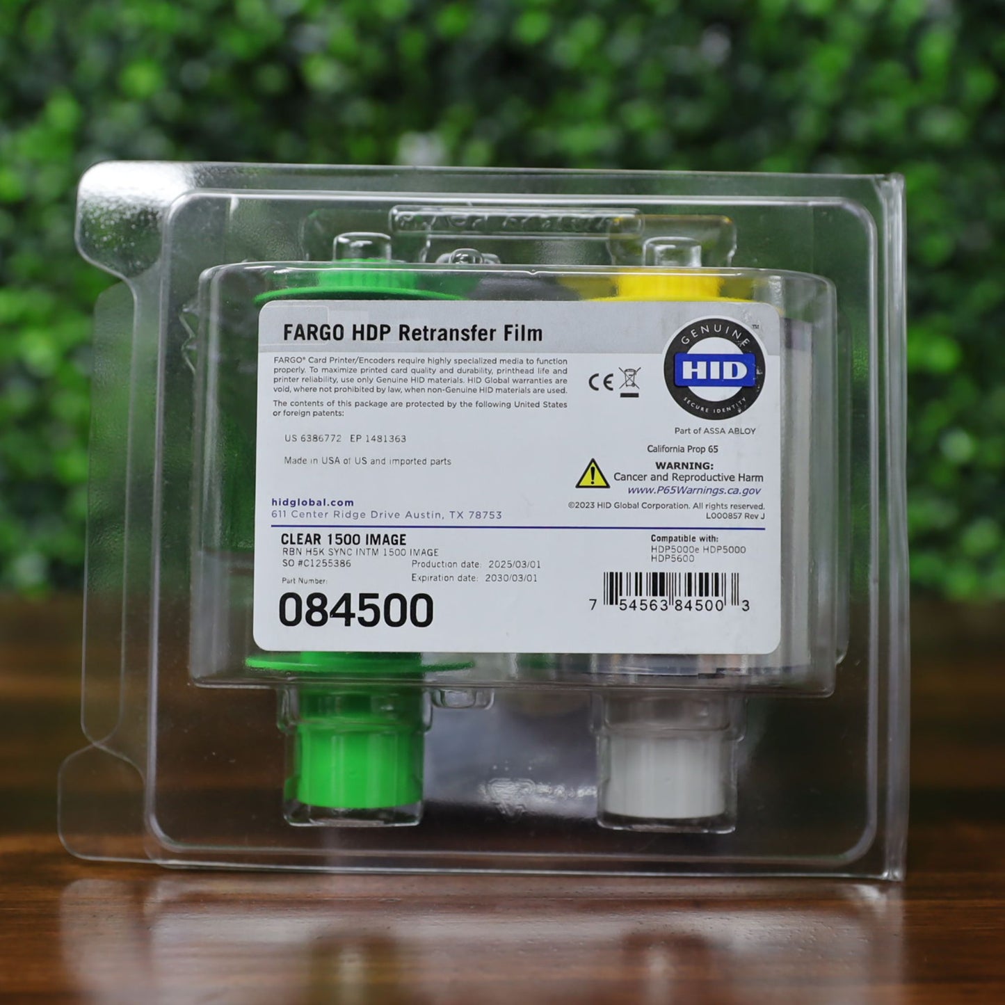 Fargo 84500 retransfer film in sealed retail clamshell packaging with visible part number, barcode, Genuine HID logo, and compatibility with HDP5000 and HDP5600 printers. Photographed and sold by Specialist ID, an authorized HID Fargo dealer.