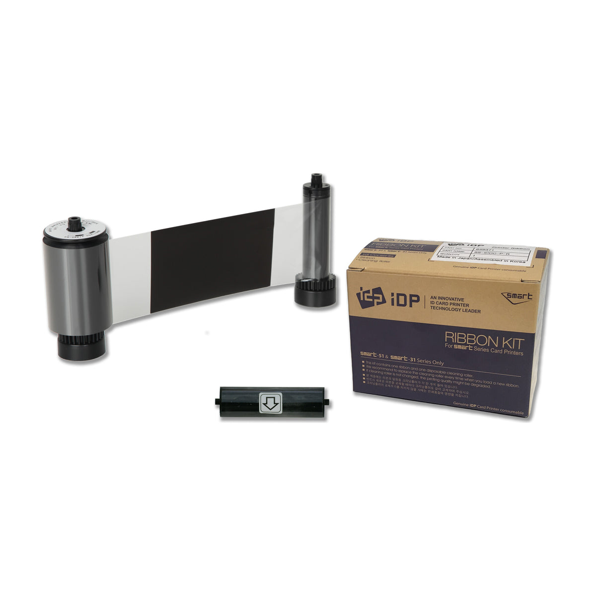 IDP 659385 KO ribbon roll showing a black panel followed by clear overlay film, with its disposable cleaning roller and SMART-31 and SMART-51 ribbon box