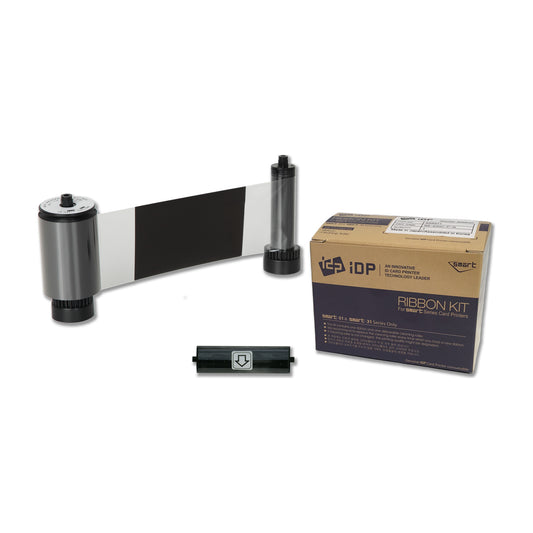 IDP 659385 KO ribbon roll showing a black panel followed by clear overlay film, with its disposable cleaning roller and SMART-31 and SMART-51 ribbon box