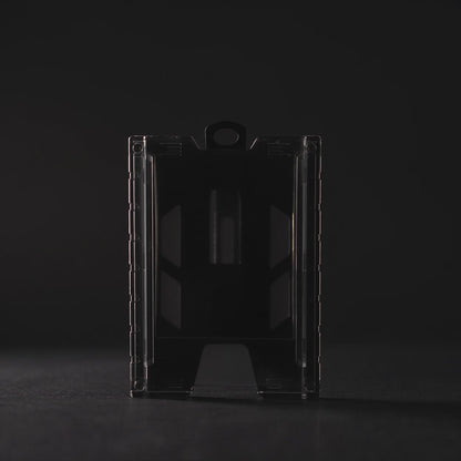 Product film of the black TEST-123 rigid vertical ID badge holder: the holder lit against a dark background, close-up detail on the metal spring belt clip and the Specialist ID name molded into the side rail, and the holder standing on a white background. Includes background music.