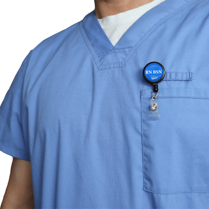 A person wearing light blue scrubs has the RN BSN Badge Buddy Reel with Swivel Spring Clip, combining a badge buddy and retractable reel in one, attached to their chest badge holder.