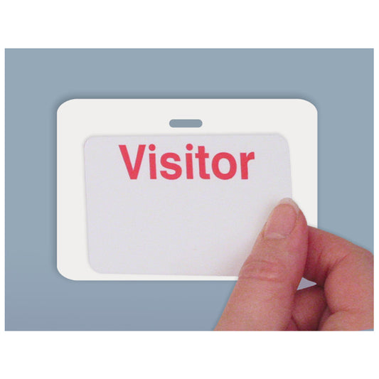 A hand is holding a white badge with the word "Visitor" in red letters, placed against a blue background. The badge is attached using a Reusable 4 X 3 Cardbacker Badge Back, Box of 500 (P/N 05661), ensuring it stays securely in place.