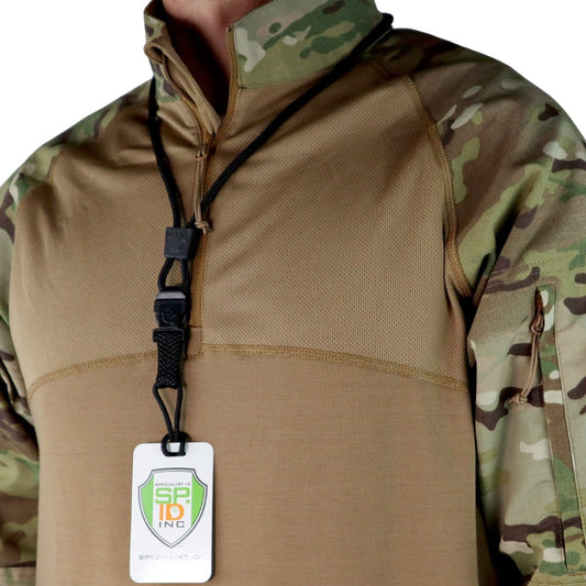 A person wearing a camouflage-patterned military-style shirt with a beige chest area. Around their neck, a black EK Lanyard Plus with Detachable Soft End (10252) by EK USA with an ID card showcases the logo "SP-19 INC." This outfit perfectly complements an outdoor lifestyle.