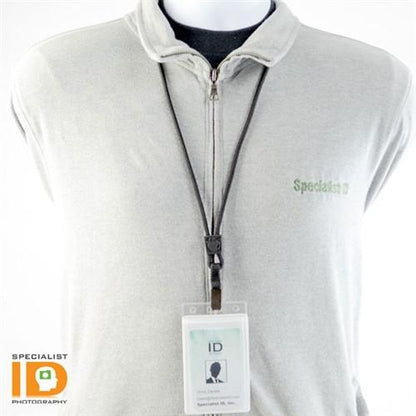 A person wearing a grey zip-up jacket with a Specialist ID card hanging from an EK Lanyard with Bulldog Clip (10329) by EK USA around their neck. The ID card features the Specialist ID logo and a silhouette.