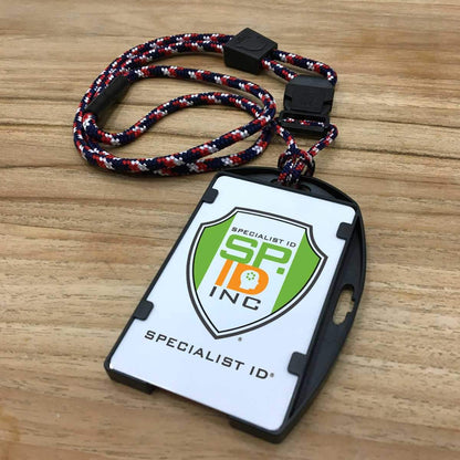 A EK USA RFID Blocking Dual Sided Badge Holder with Heavy Duty Breakaway / Quick Release Lanyard (10943) by EK USA with a SP Inc logo, resting on a wooden surface. Sold by Specialist ID.