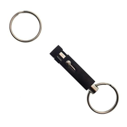 A detachable keychain, known as the Key-Bak #1101 Quick Release Pull-Apart Key Ring, features two metal key rings connected by a black rectangular connector, allowing you to easily organize keys and separate vehicle and house keys when needed.