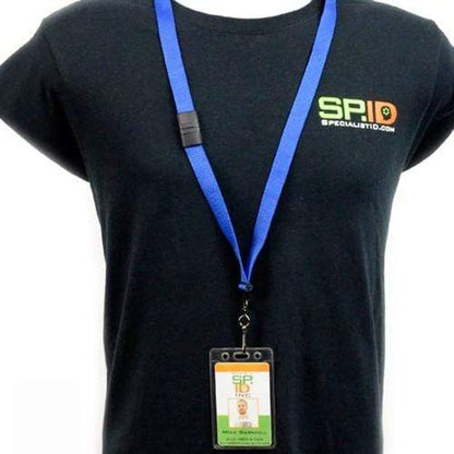 Person wearing a black T-shirt with a Specialist ID logo, blue lanyard, and an ID badge in a Vertical Heavy Duty Vinyl ID Badge Holder with Reinforced Edges and Orange Peel Texture (1815-1100). The holder features reinforced edges and an orange peel texture.