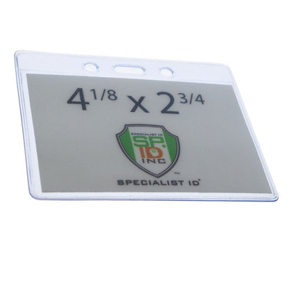 A Clear Vinyl Horizontal Military Card Size Badge Holder (P/N 1815-1200) with dimensions 4 1/8 x 2 3/4 inches, featuring the Specialist ID Inc. logo; perfect for government/military cards.
