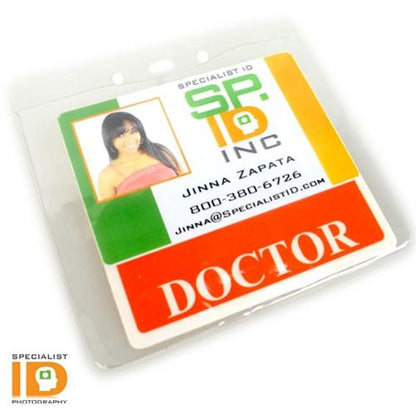 Photo ID badge for Jinna Zapata, labeled "Doctor," from Specialist ID Inc., displayed in a Clear Vinyl Horizontal Badge Holder With Clip And Chain Holes (P/N 1815-1405). It shows her name, email, and phone number with a photo of her in a pink top.