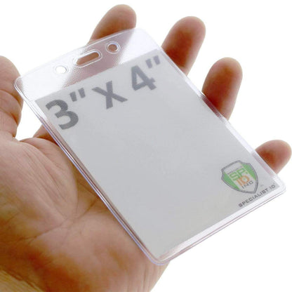 A hand holds a Heavy Duty 3 X 4 Name Badge Holder - 3x4 Vertical Textured Convention Conference Card Protector (P/N 1815-1450) with a clear plastic front displaying the text "3" X 4" and a small logo in one corner.
