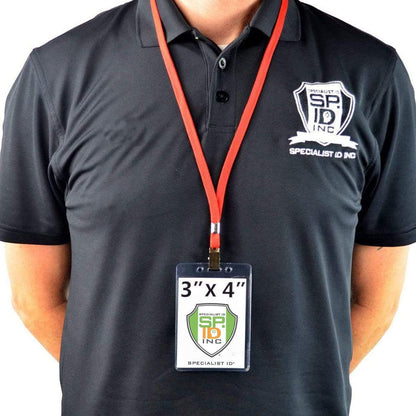 The person is wearing a black polo shirt with a Specialist ID Inc logo and a red lanyard holding a Heavy Duty 3 X 4 Name Badge Holder - 3x4 Vertical Textured Convention Conference Card Protector (P/N 1815-1450) made of durable vinyl.