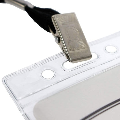 Close-up of a credit card sized ID card inside a Standard Vertical Vinyl ID Badge Holder (1820-1050), attached to a black lanyard with a metal clip, highlighting its durability.