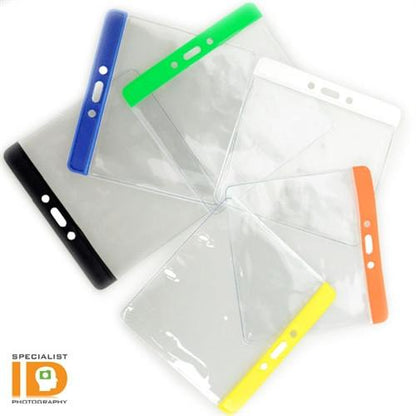 A group of five Extra Large Color Code Badge Holders for 4x3 Badges - Horizontal Vinyl with Color Bar (1820-120X) with colored tops (black, blue, green, white, and orange) arranged in a fan shape. The Specialist ID logo is visible in the bottom left corner of each vinyl badge holder.