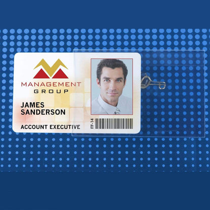 Close-up of an ID badge for James Sanderson from Management Group, securely displayed in a Clear Rigid Vinyl 4X3 Name Tag Holder W/ Nickel Plated Steel Pin (P/N 1825-2400). Identifying him as an Account Executive with a photograph and barcode, the badge measures 4" X 3".