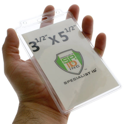 A hand holding a Vertical Extra Large 3 1/2 x 5 1/2 Credential Holder with Flap (P/N 1840-1605) with a Specialist ID insert, showcasing the size 3 1/2" x 5 1/2".