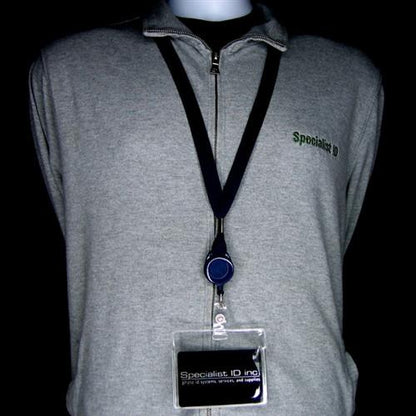 Gray zip-up jacket with "Specialist ID" embroidered on the left chest. A lanyard with a retractable badge holder and a Clear Flexible Vinyl Horizontal Proximity Card Holder (P/N 1840-5010) is worn around the neck. The background is black.