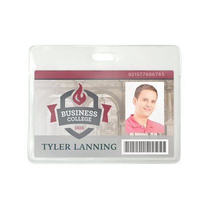 A college ID card for Tyler Lanning showing a photo, barcode, and student number 921577886785 is securely housed in a Clear Flexible Vinyl Horizontal Proximity Card Holder (P/N 1840-5010). The card features the Business College logo on a background of a building and is easily accessible with a top load design and strap clip attachment.