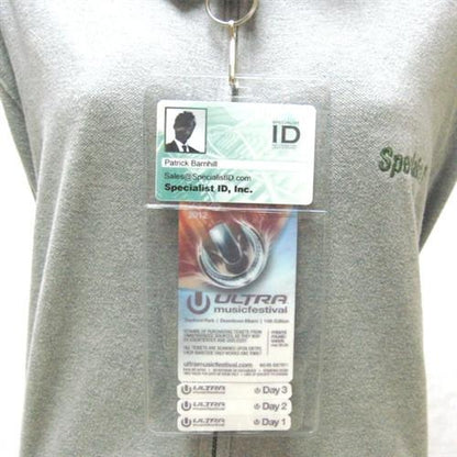 A person is wearing a grey shirt and displaying a Clear 4" X 7 1/2" Vinyl Vertical Large Badge Holder With Two Pockets (P/N 1840-5052) containing an ID and a pass for Ultra Music Festival with access for three days. The ID belongs to Patrick Barnhill from Specialist ID, Inc.