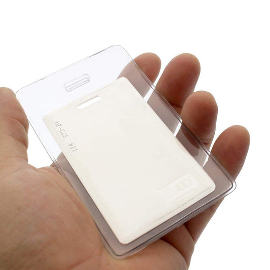 A hand holding a Heavy Duty Vertical Proximity Card Holder (P/N 1840-5057) with a white blank card inside.
