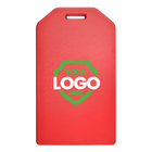 This Custom Rigid Plastic Luggage Tag Holders with 6" Clear Loop - Personalize with Your Logo, perfect for custom luggage tags, features a slot at the top for attaching a strap. It displays a green shield with the text "Your Logo Here" in the center, making it ideal for promotional giveaways and boosting brand awareness.