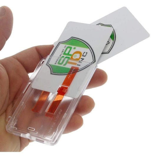 A hand is holding a 2 Card Badge Holder with Slide (P/N 1840-6400) with a red extractor slide mechanism, securing a business card partially inserted. The card displays a logo with a green shield and the text "SIP-10" in black and green.