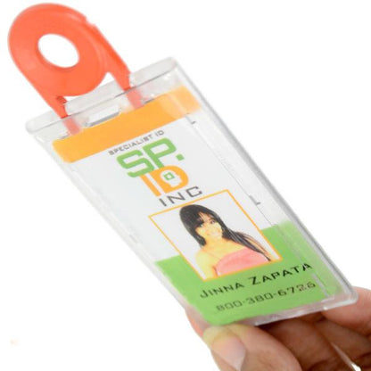 A hand holds a Clear Vertical Locking Plastic Card Holder (P/N 1840-6630) with an orange clip, displaying a card for "SP ID INC" with a picture and the name "Jinna Zapata," and a phone number.
