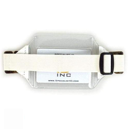 A transparent plastic credit card size ID holder featuring a white adjustable strap and black buckle, Vinyl Horizontal Arm Band Badge Holder With Elastic Strap (P/N 1840-7000). Sold by Specialist ID.