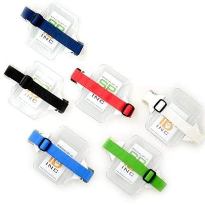 Six Oversize Vertical Armband Badge Holders (1840-7110) in different colors (blue, black, white, and green) displayed on heavy-duty vinyl packaging. Sold by Specialist ID.