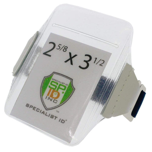 A clear Oversize Vertical Armband Badge Holder (1840-7110) with a white wrist strap features a Specialist ID logo and displays the dimensions 2 5/8 x 3 1/2 inches.