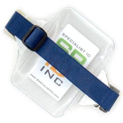 A clear, heavy-duty oversize vertical armband badge holder (1840-7110) with a visible blue strap displays a card that reads "Specialist ID Inc." in green and orange text.