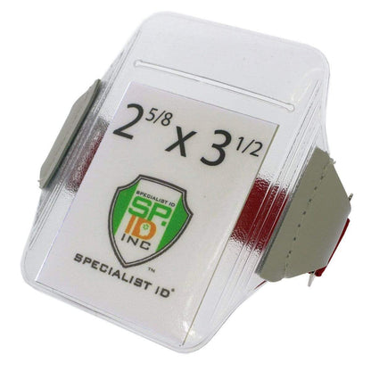 A clear plastic Oversize Vertical Armband Badge Holder (1840-7110) with gray straps, displaying a card with the dimensions "2 5/8 x 3 1/2" and the "Specialist ID Inc" logo, made from heavy-duty vinyl for enhanced durability.