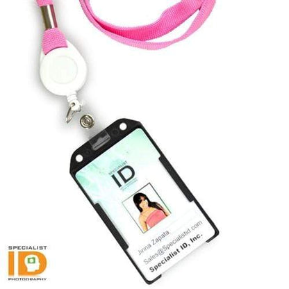 A Vertical Open Face Plastic ID Holder (1840-816X) with a photo ID in a vertical plastic card holder, featuring a pink lanyard and retractable badge reel. The rigid plastic design securely displays the person's image, name, email, and company,
Specialist ID, Inc.