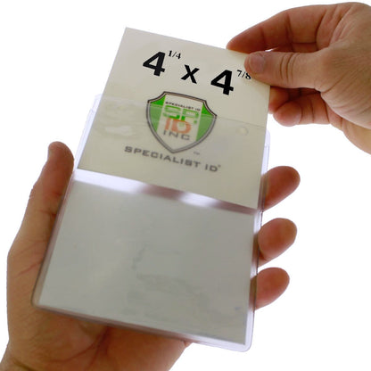 A person is inserting a card with dimensions "4 1/4 x 4 7/8" into a clear plastic holder labeled "Two Pocket Event Badge Holder with 4x5 and 4x3 Sleeves - Clear Vertical Credential Holder (1860-4000)," featuring two pockets: one 4x5 and the other 4x3, with a clear front and back.